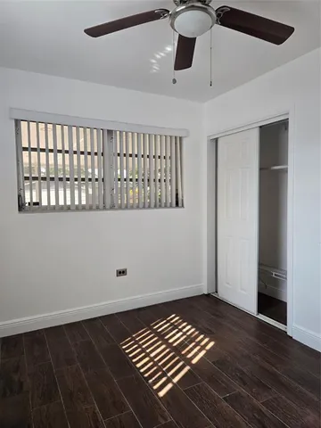 a view of a chair and table in backyard of the house