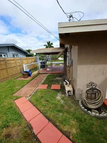 a view of an empty room with a floor to ceiling window and stairs