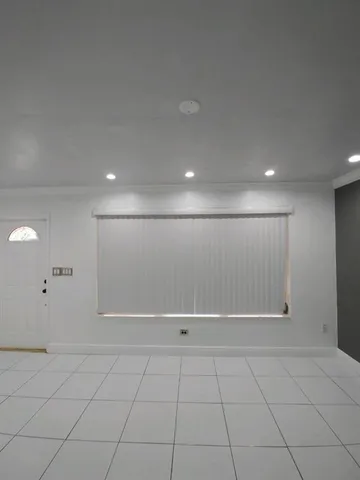 a view of an empty room with glass door