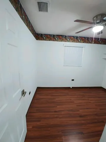 a view of a refrigerator in wooden floor