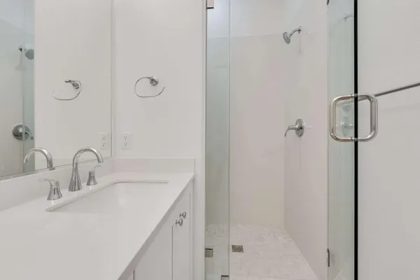 a bathroom with a sink and shower
