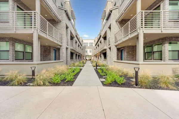 front view of a brick house with a small yard