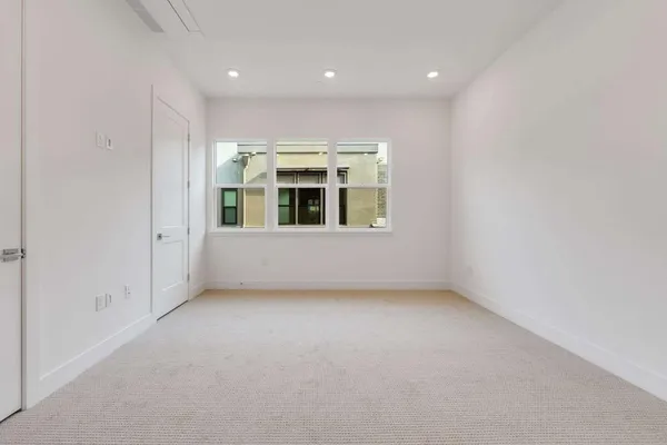 an empty room with a empty space and windows