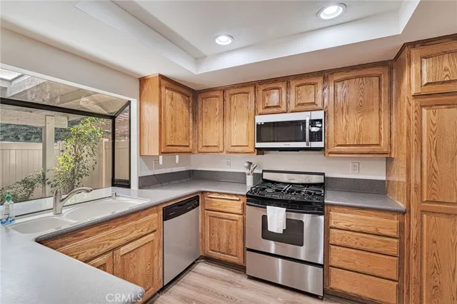 a kitchen with stainless steel appliances granite countertop a sink stove and cabinets