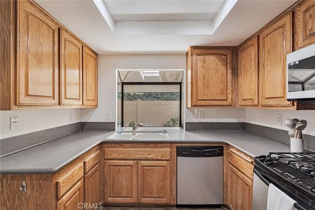 a kitchen with kitchen island granite countertop stainless steel appliances and cabinets