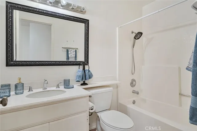 an empty room with windows and ceiling fan