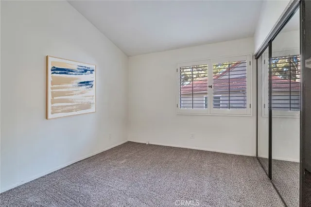 a bedroom with a bed chair and window