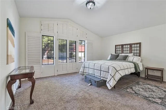 a bed sitting in a bedroom next to a window