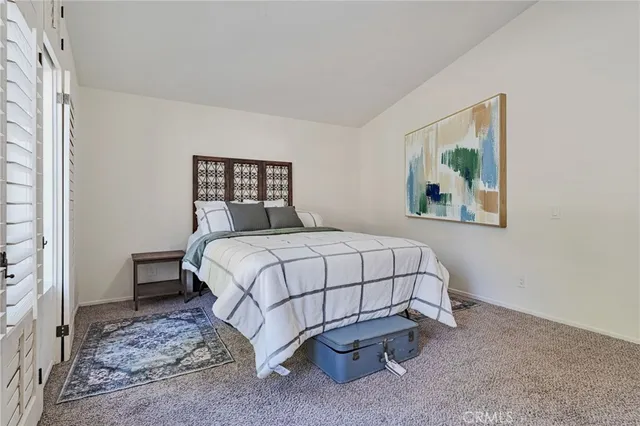 a bedroom with bed and wall painting