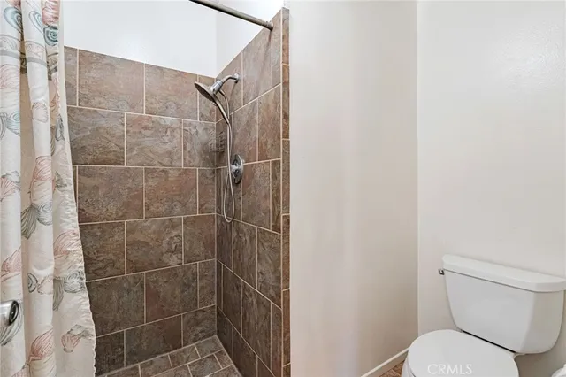 a en suite bathroom with a granite countertop sink and a mirror