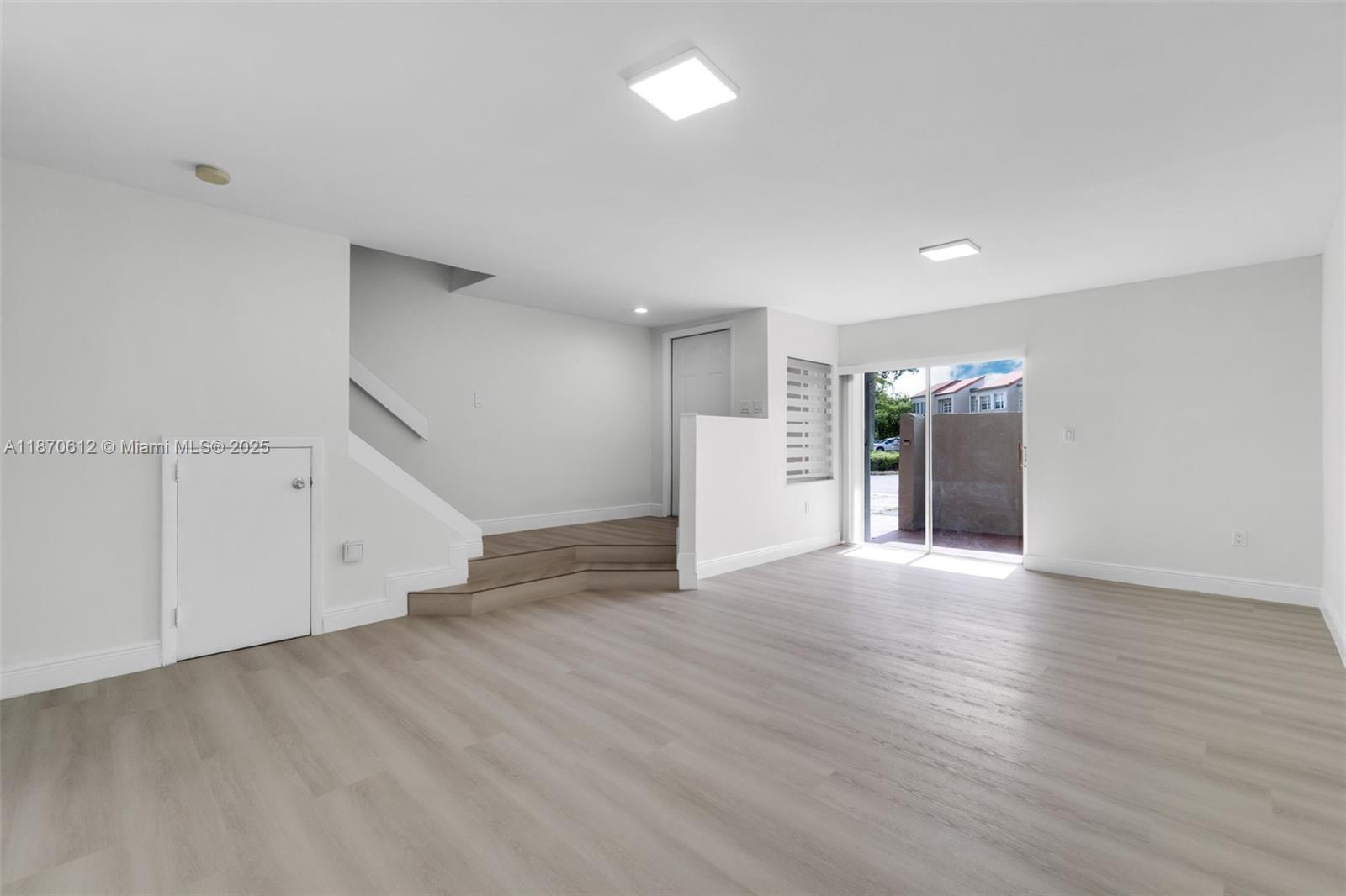 6514 Southwest 128th Place, Unit 6514 Miami, FL 33183 - Photo 1 of 46 a view of an empty room with wooden floor