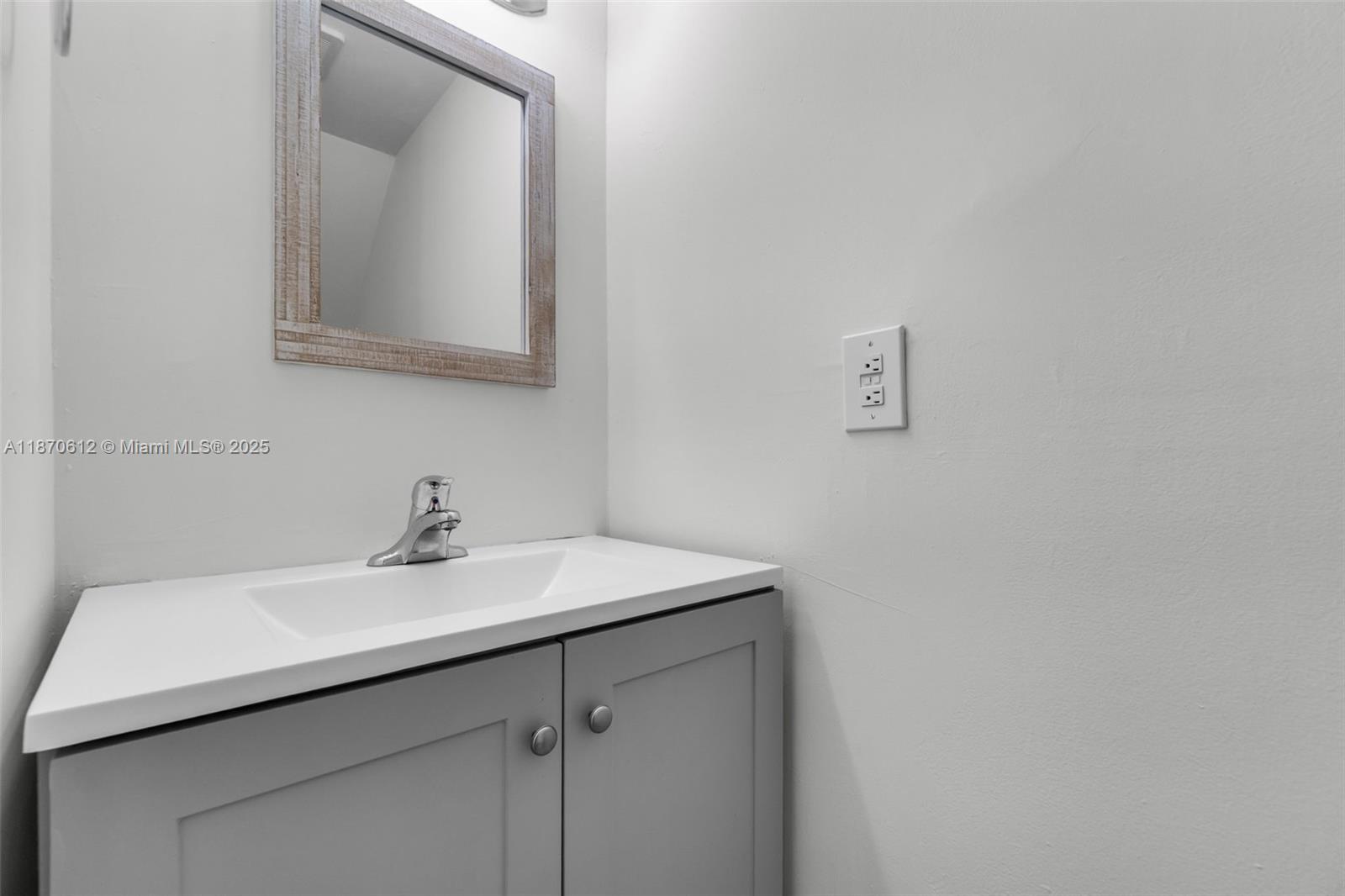 6514 Southwest 128th Place, Unit 6514 Miami, FL 33183 - Photo 15 of 46 a bathroom with a sink vanity and mirror