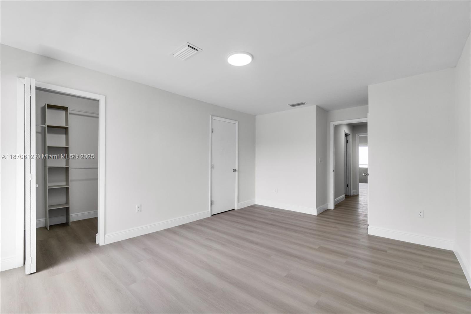 6514 Southwest 128th Place, Unit 6514 Miami, FL 33183 - Photo 19 of 46 a view of an empty room with wooden floor and closet