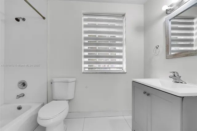 a white toilet sitting next to a bathroom sink