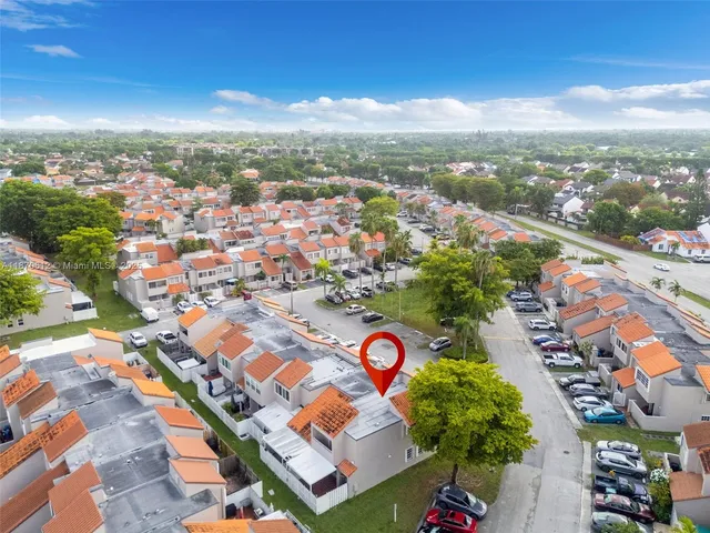 an aerial view of residential houses with outdoor space