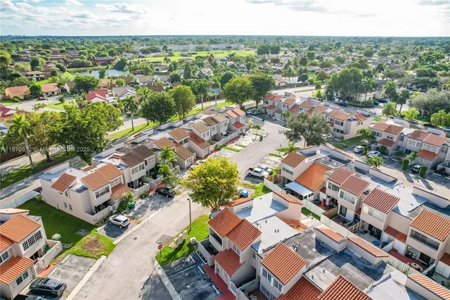 an aerial view of residential houses with outdoor space