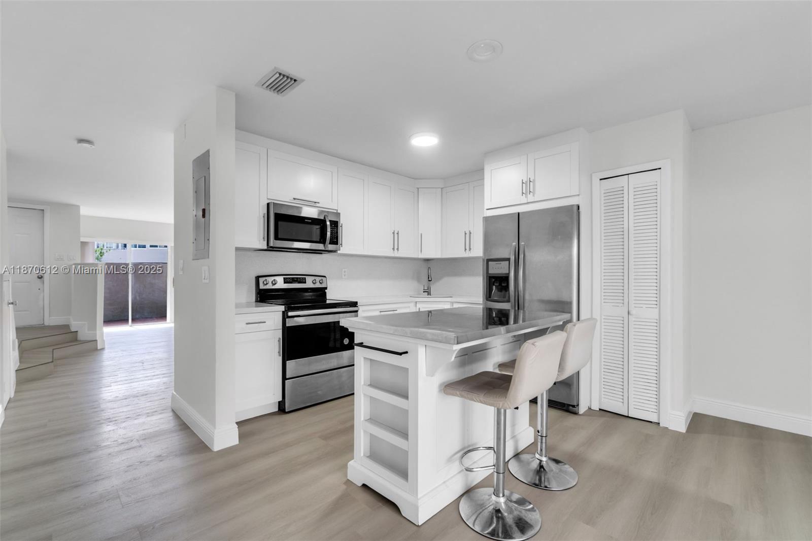 6514 Southwest 128th Place, Unit 6514 Miami, FL 33183 - Photo 7 of 46 a kitchen with stainless steel appliances a microwave a stove a refrigerator and a sink