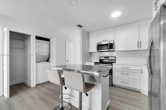 a kitchen with a stove a sink and a refrigerator