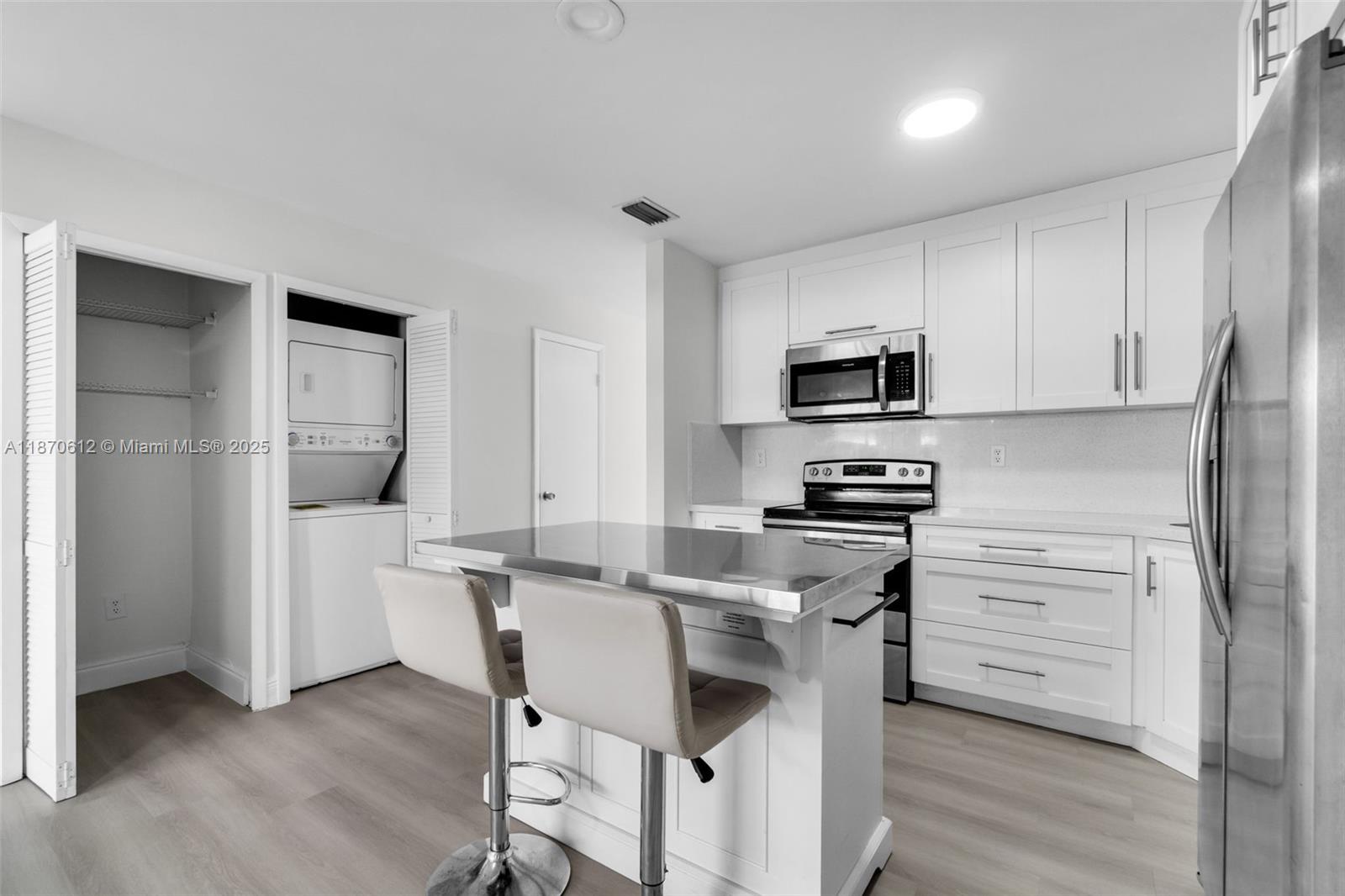 6514 Southwest 128th Place, Unit 6514 Miami, FL 33183 - Photo 8 of 46 a kitchen with a stove a sink and a refrigerator