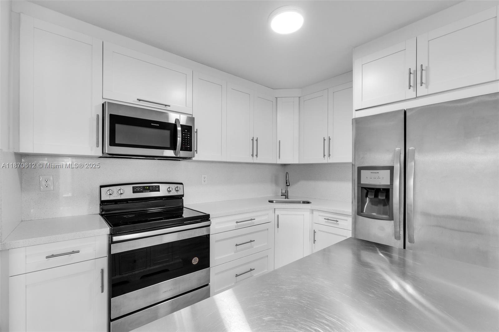 6514 Southwest 128th Place, Unit 6514 Miami, FL 33183 - Photo 10 of 46 a kitchen with cabinets stainless steel appliances and wooden floor