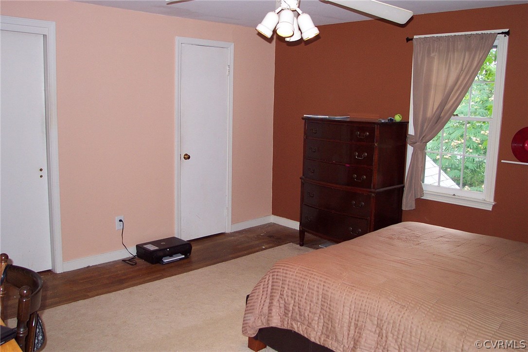 3901 Cedar Grove Road Richmond, VA 23235 - Photo 10 of 31 a bedroom with a bed and a chandelier