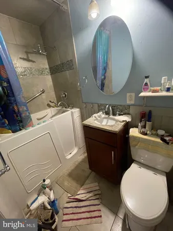 a bathroom with a toilet sink and mirror