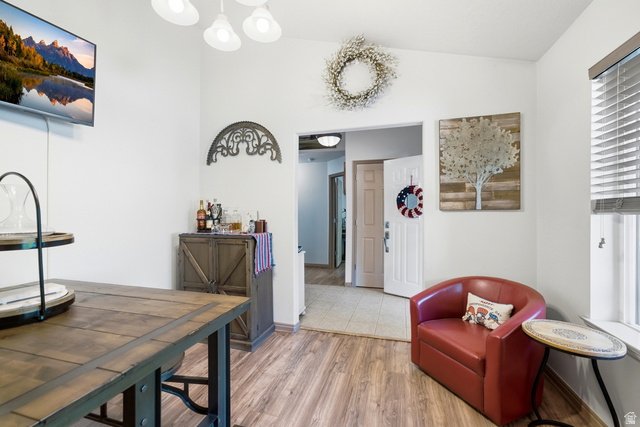 5196 Rodeo Circle Oakley, UT 84055 - Photo 28 of 57 Vaulted ceiling with a four-light fixture, wood-finish flooring, white painted walls, and a window with horizontal blinds