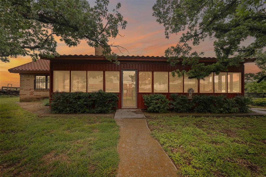 2900 Peel Road Springtown, TX 76082 - Photo 19 of 34 a front view of a house with garden