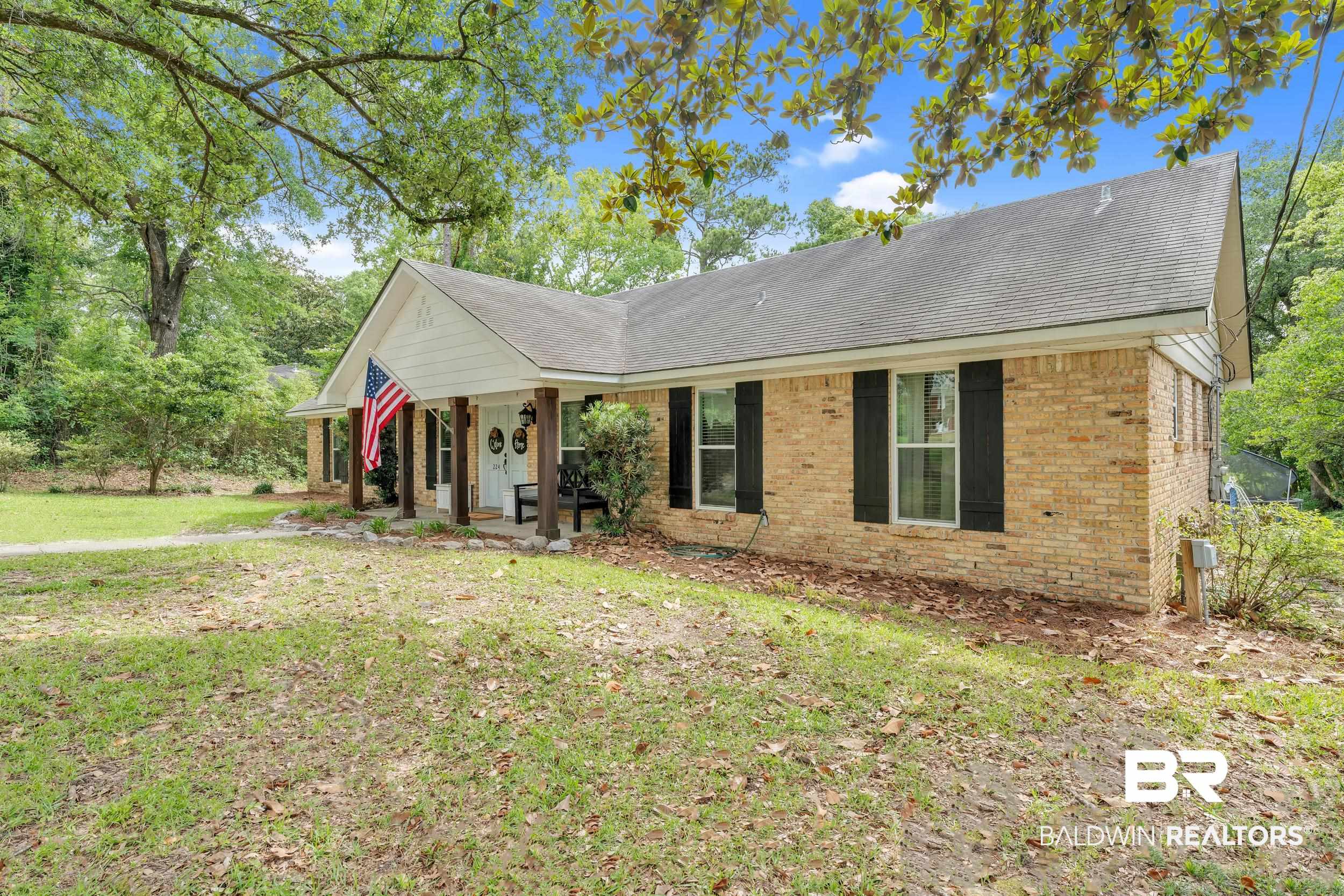 224 Cache Circle Mobile, AL 36611 - Photo 40 of 42 Ranch-style house with brick siding, a porch, a front yard, and a shingled roof