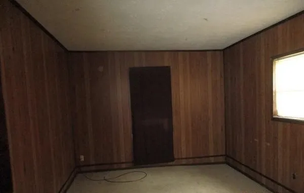 a view of door with wooden walls