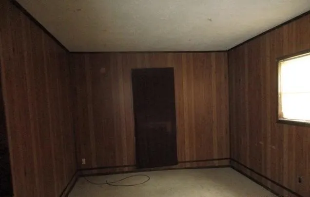 a view of door with wooden walls