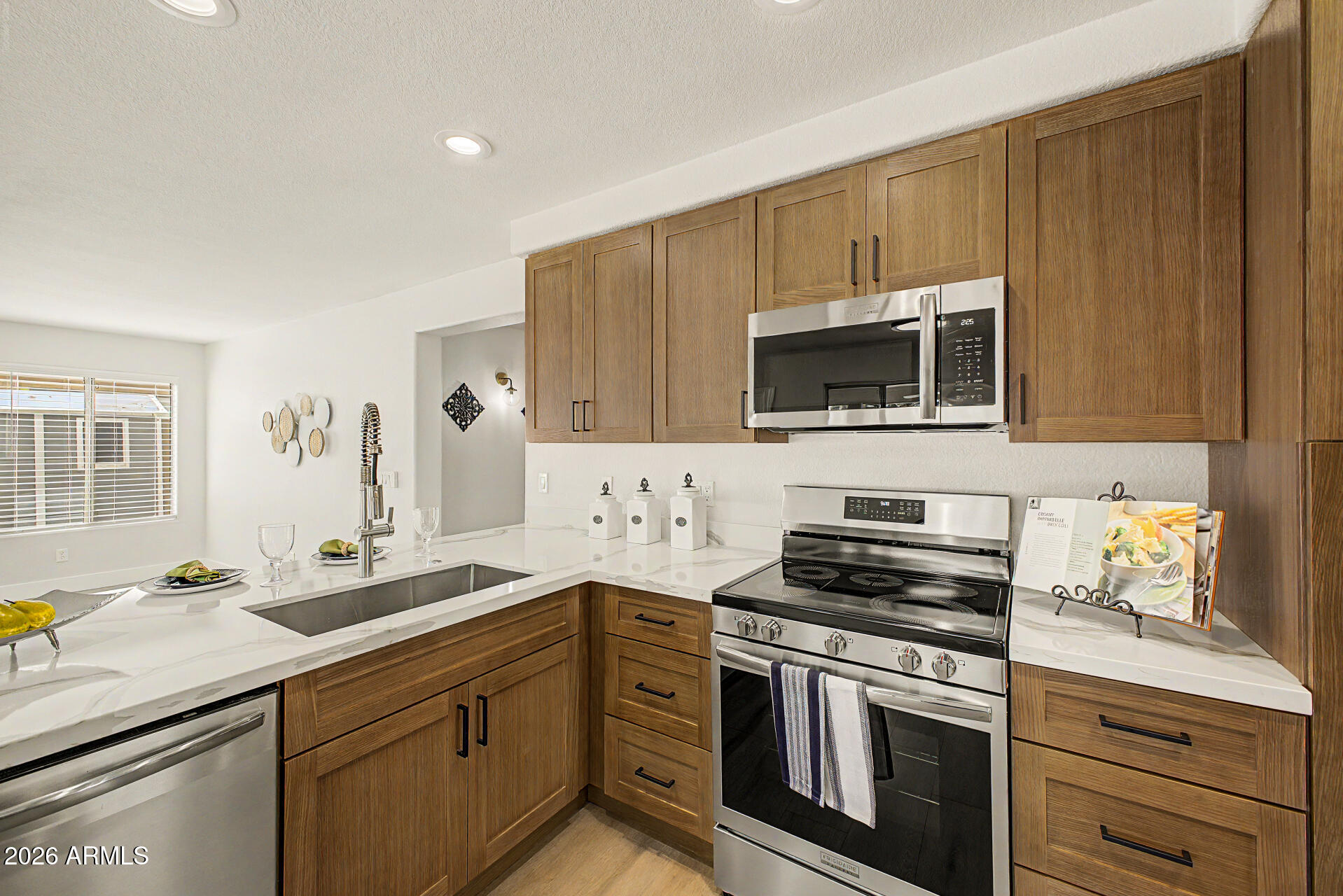 1743 East Redfield Road Gilbert, AZ 85234 - Photo 11 of 30 a kitchen with stainless steel appliances a stove a sink and a microwave
