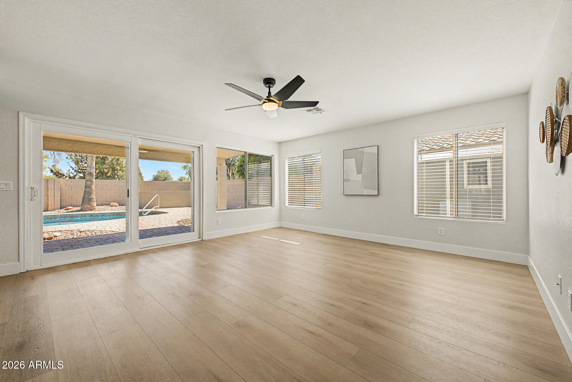 1743 East Redfield Road Gilbert, AZ 85234 - Photo 13 of 30 a view of an empty room with a window and wooden floor