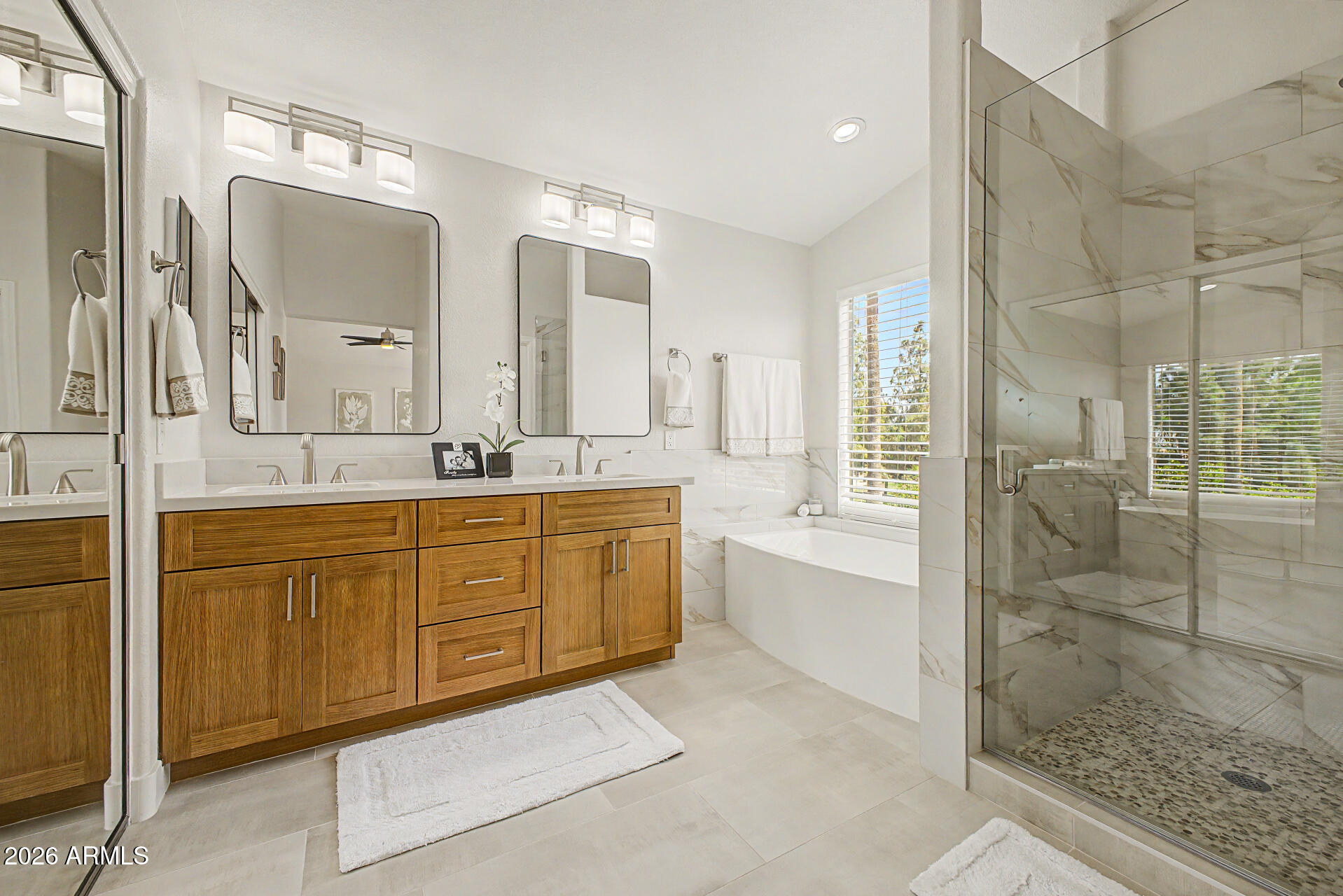 1743 East Redfield Road Gilbert, AZ 85234 - Photo 20 of 30 a spacious bathroom with a shower sink and mirror