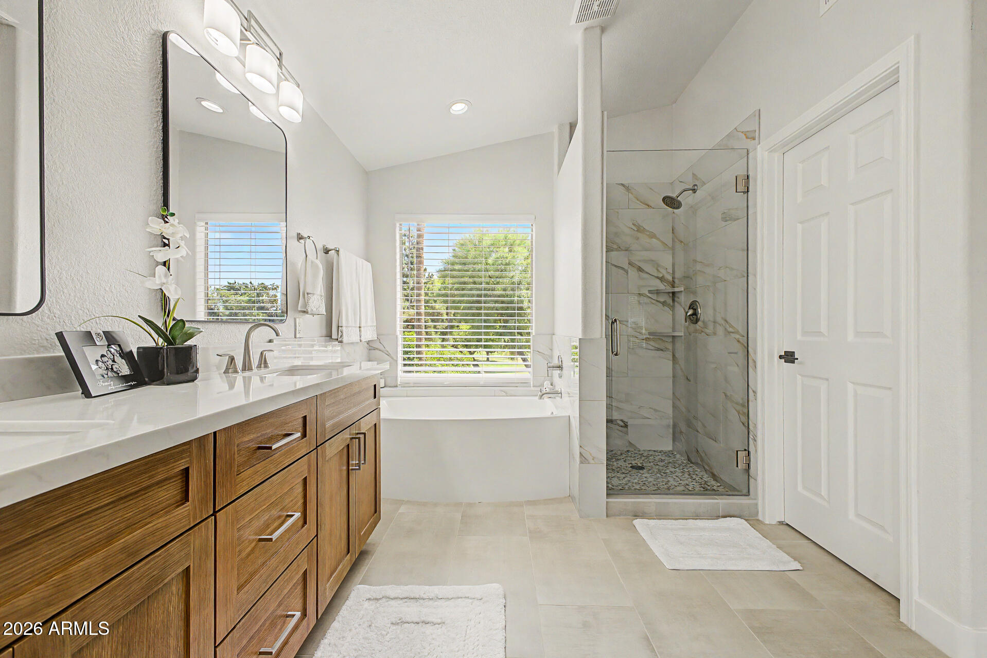 1743 East Redfield Road Gilbert, AZ 85234 - Photo 21 of 30 a spacious bathroom with a shower sink and mirror