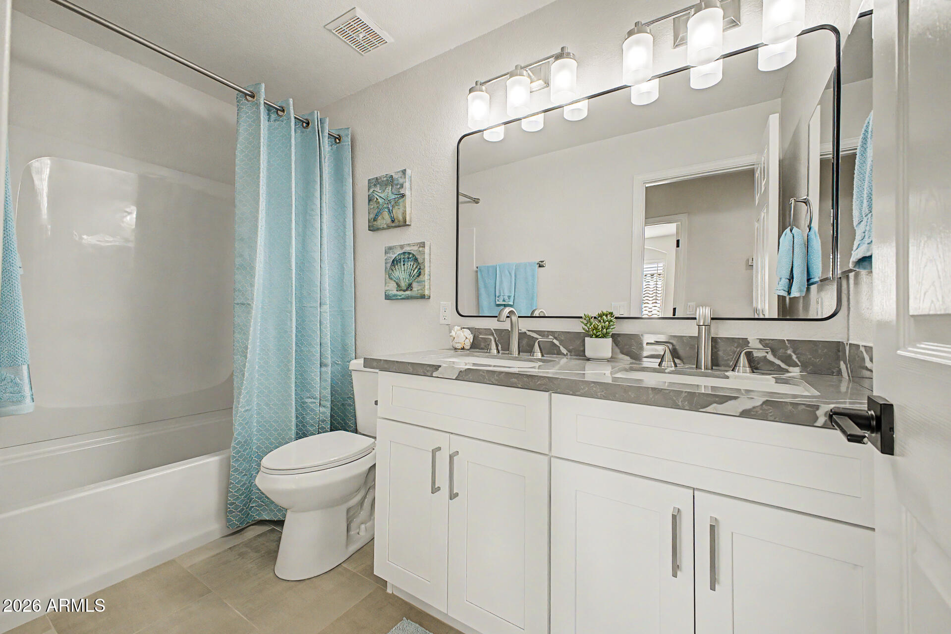 1743 East Redfield Road Gilbert, AZ 85234 - Photo 24 of 30 a bathroom with a sink a toilet and a large mirror