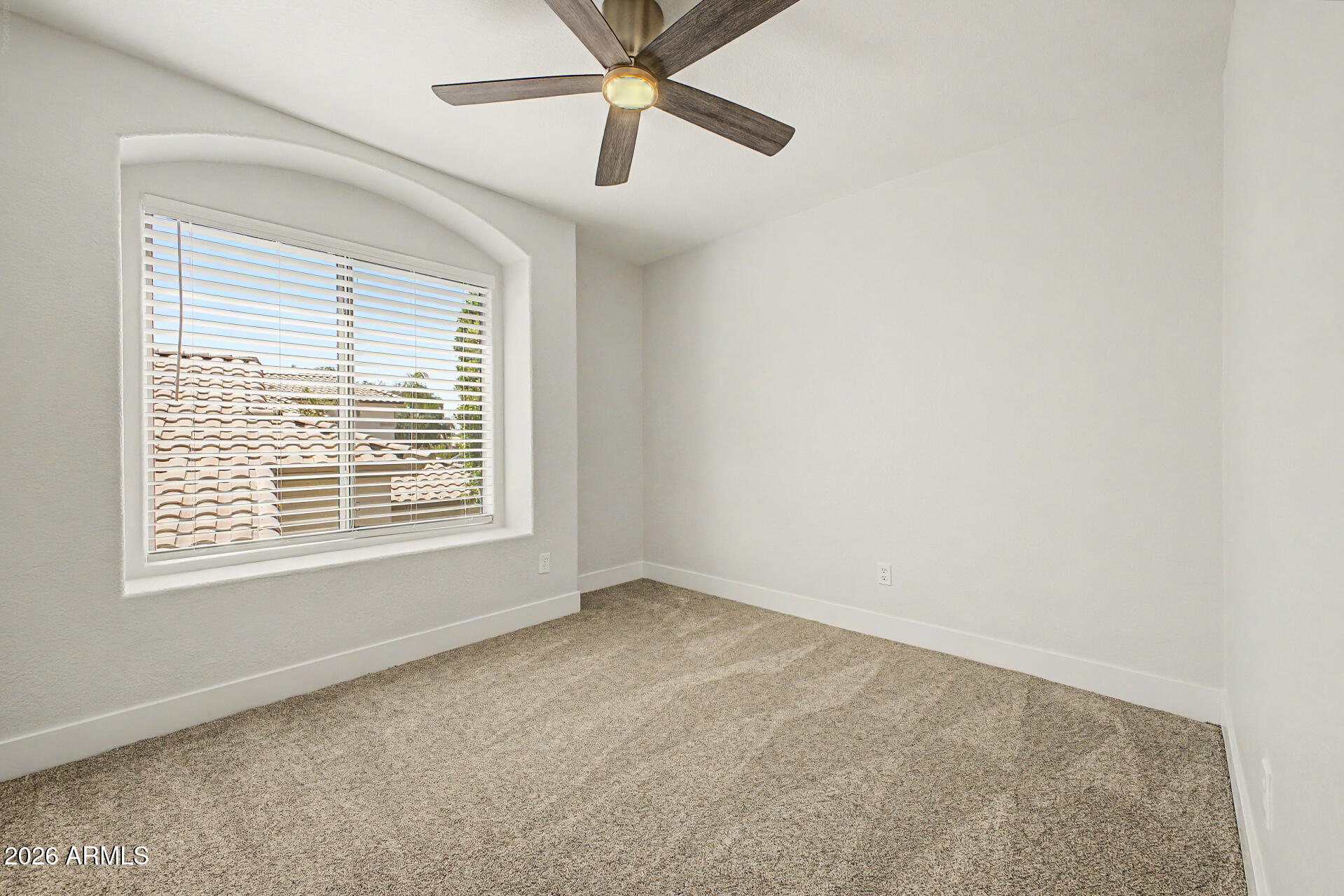 1743 East Redfield Road Gilbert, AZ 85234 - Photo 25 of 30 an empty room with a window and a fan