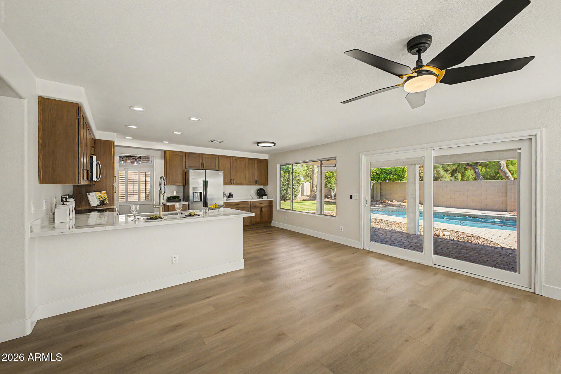 1743 East Redfield Road Gilbert, AZ 85234 - Photo 7 of 30 a view of open kitchen with wooden floor and windows