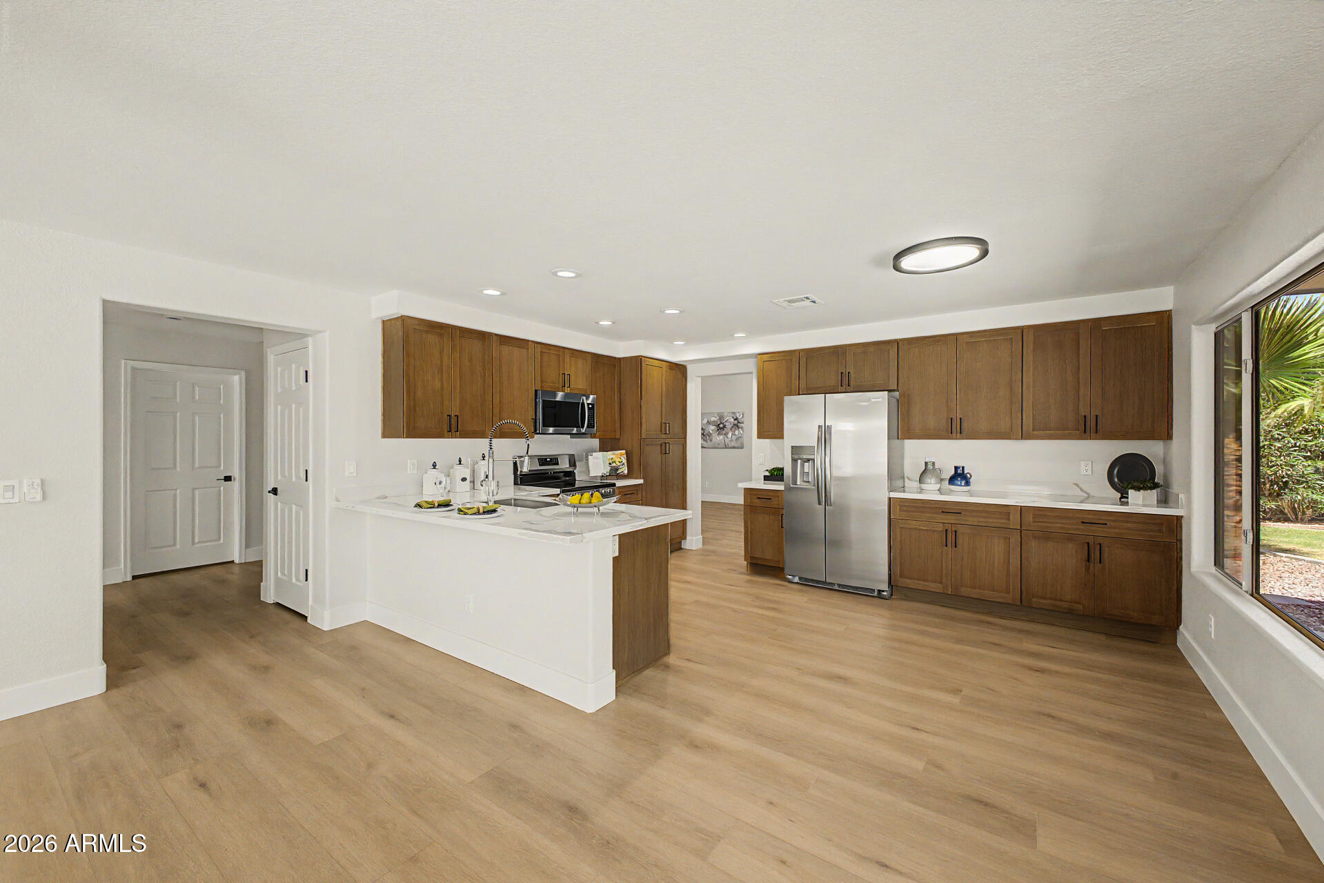 1743 East Redfield Road Gilbert, AZ 85234 - Photo 8 of 30 a large kitchen with a center island and stainless steel appliances