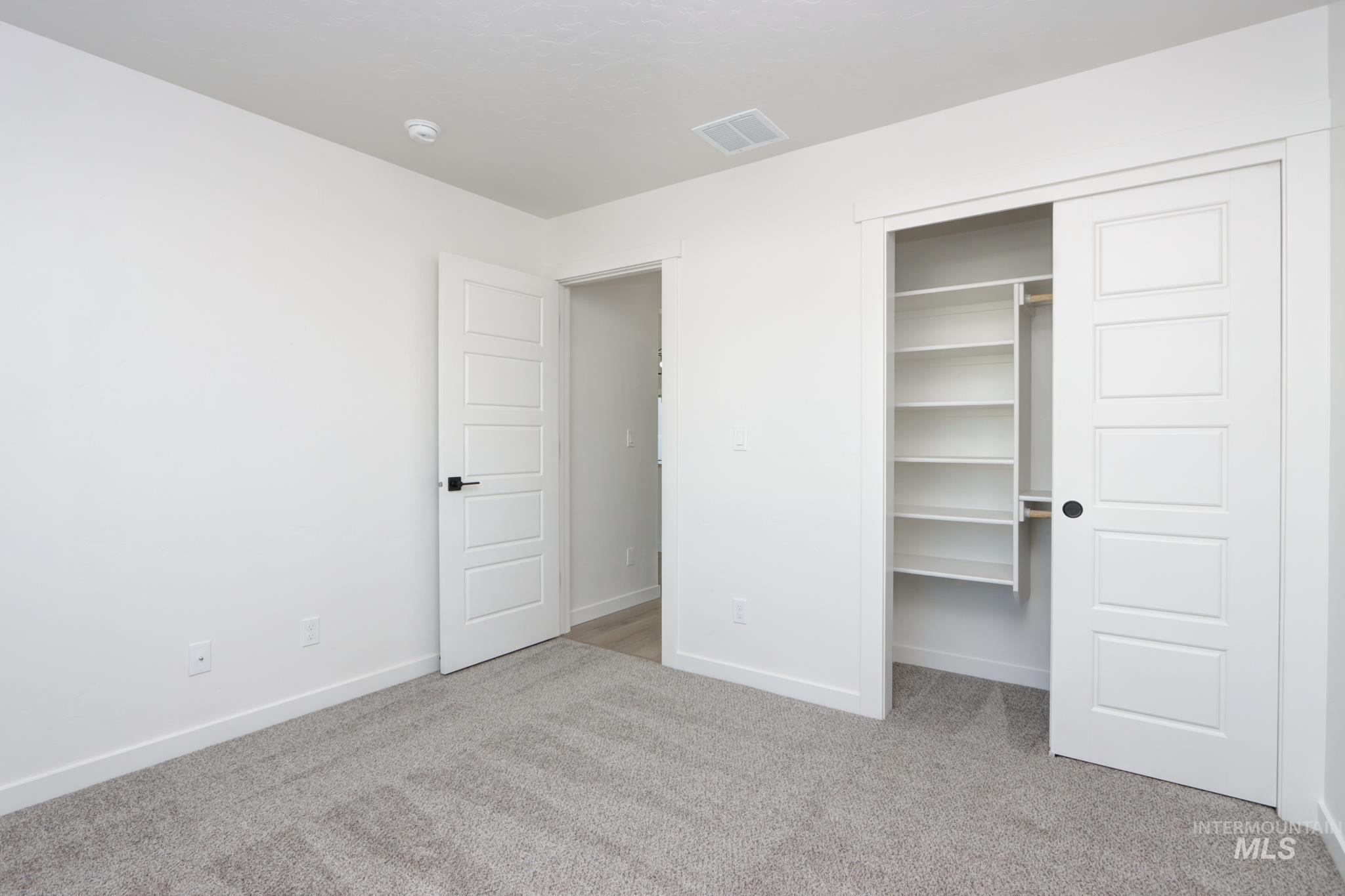 848 North 5th Street Nyssa, OR 97913 - Photo 29 of 49 Bedroom featuring light gray carpet, white walls, and white baseboards