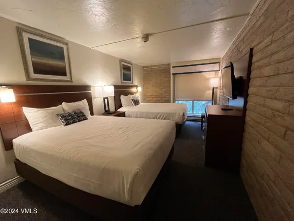 a bedroom with bed and window