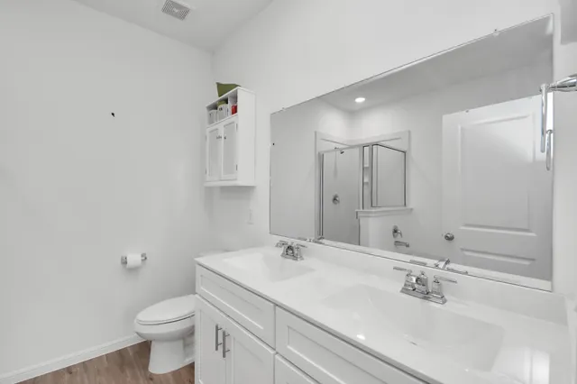 a bathroom with a sink a toilet and a mirror