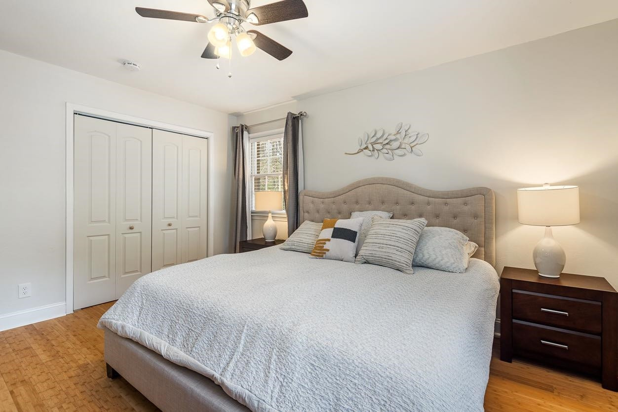 5614 Pelham Road Durham, NC 27713 - Photo 15 of 37 a bedroom with a bed and a chandelier
