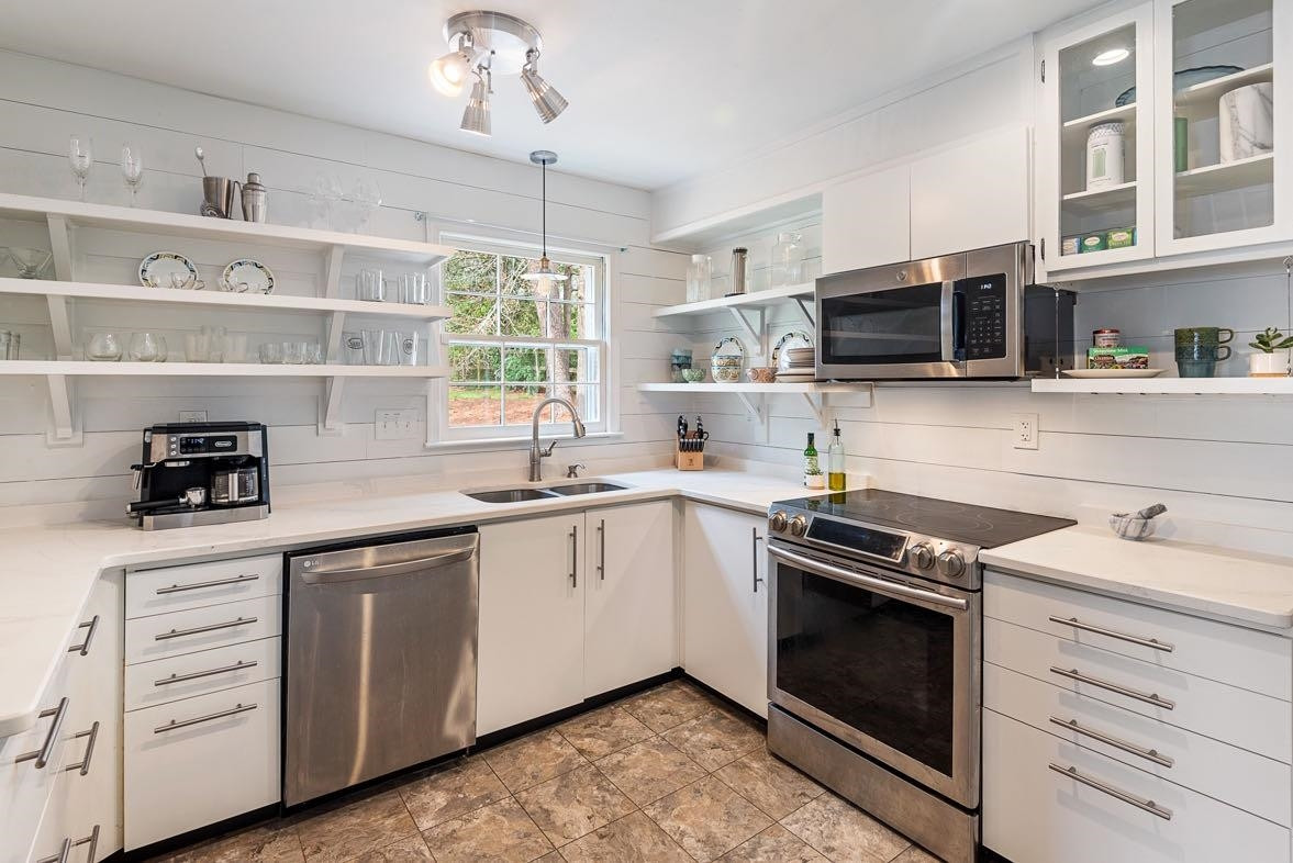 5614 Pelham Road Durham, NC 27713 - Photo 3 of 37 a kitchen with cabinets stainless steel appliances and a sink