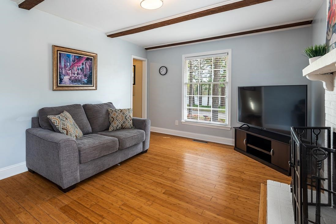 5614 Pelham Road Durham, NC 27713 - Photo 7 of 37 a living room with furniture and a flat screen tv