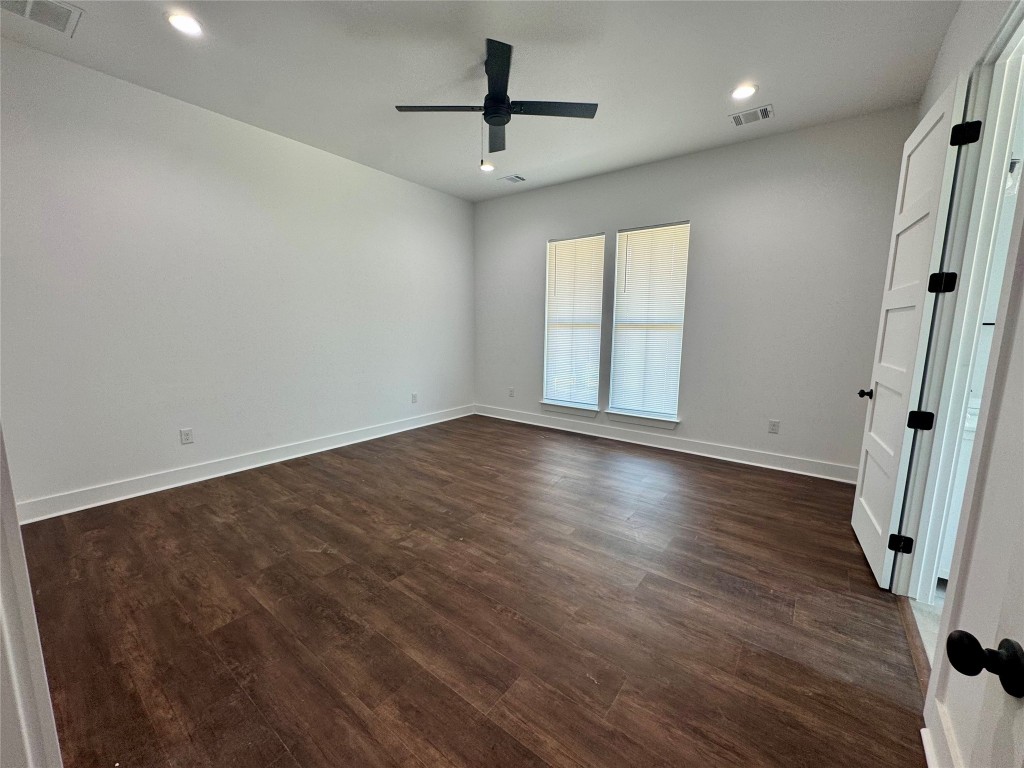 1353 Red Town Road, Unit B Elgin, TX 78621 - Photo 12 of 22 an empty room with wooden floor and a ceiling fan