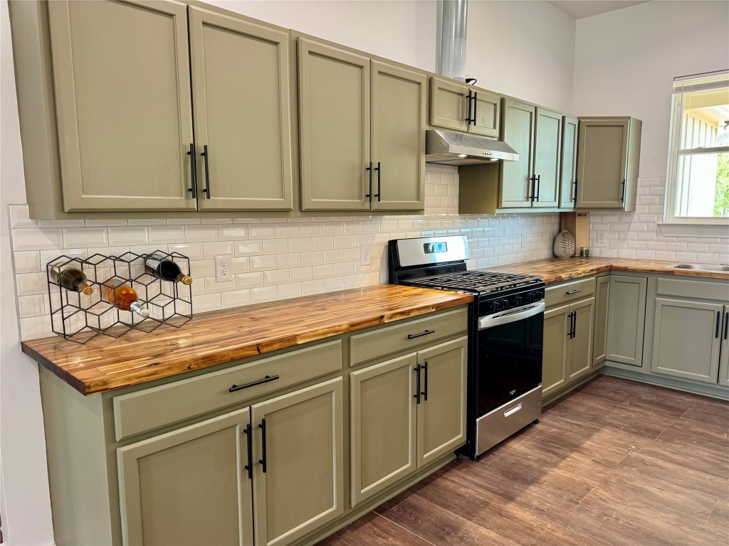 1353 Red Town Road, Unit B Elgin, TX 78621 - Photo 5 of 22 a kitchen with stainless steel appliances granite countertop a sink stove and cabinets