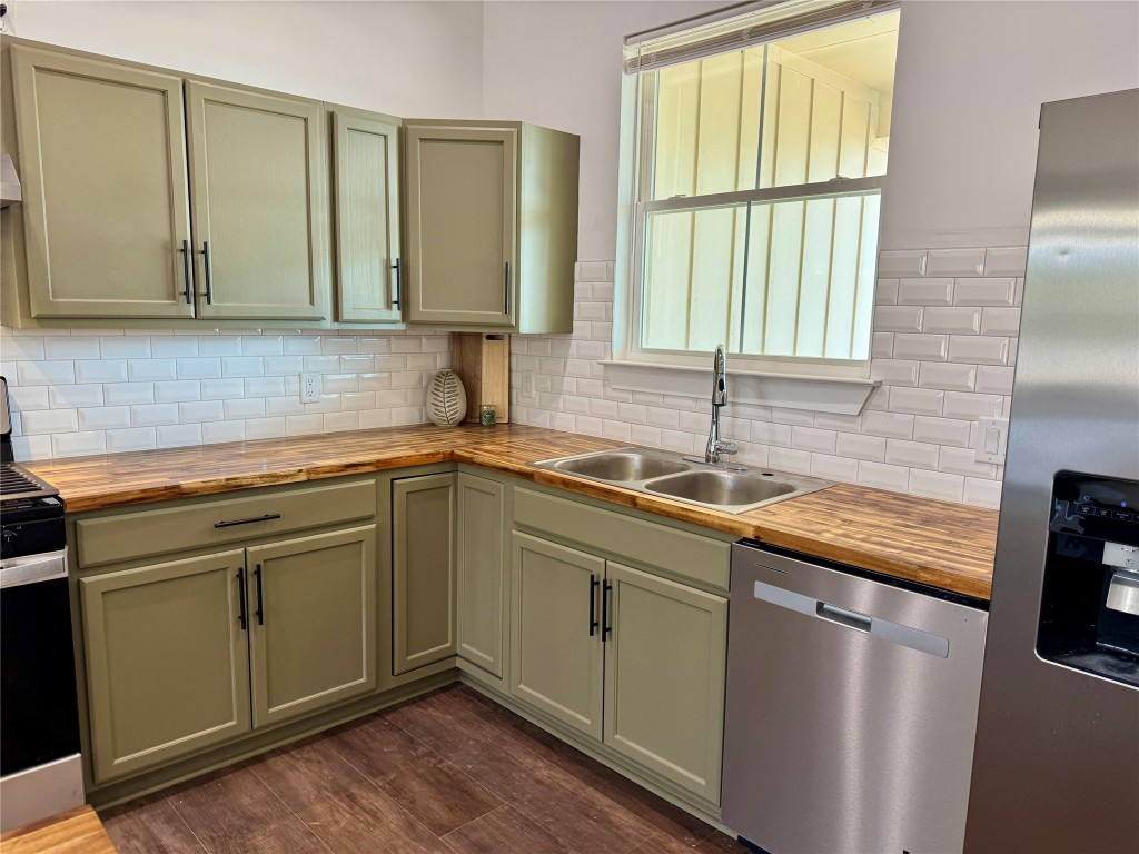 1353 Red Town Road, Unit B Elgin, TX 78621 - Photo 7 of 22 a kitchen with stainless steel appliances granite countertop a sink a stove and a refrigerator