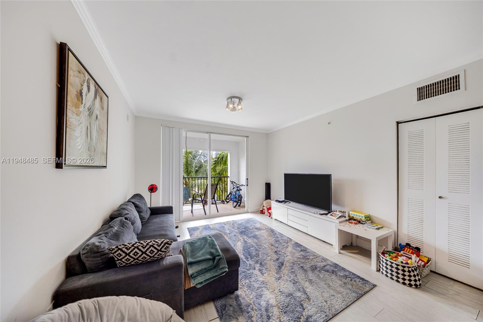 17145 North Bay Road, Unit 4506 Sunny Isles Beach, FL 33160 - Photo 2 of 10 a living room with furniture and a flat screen tv