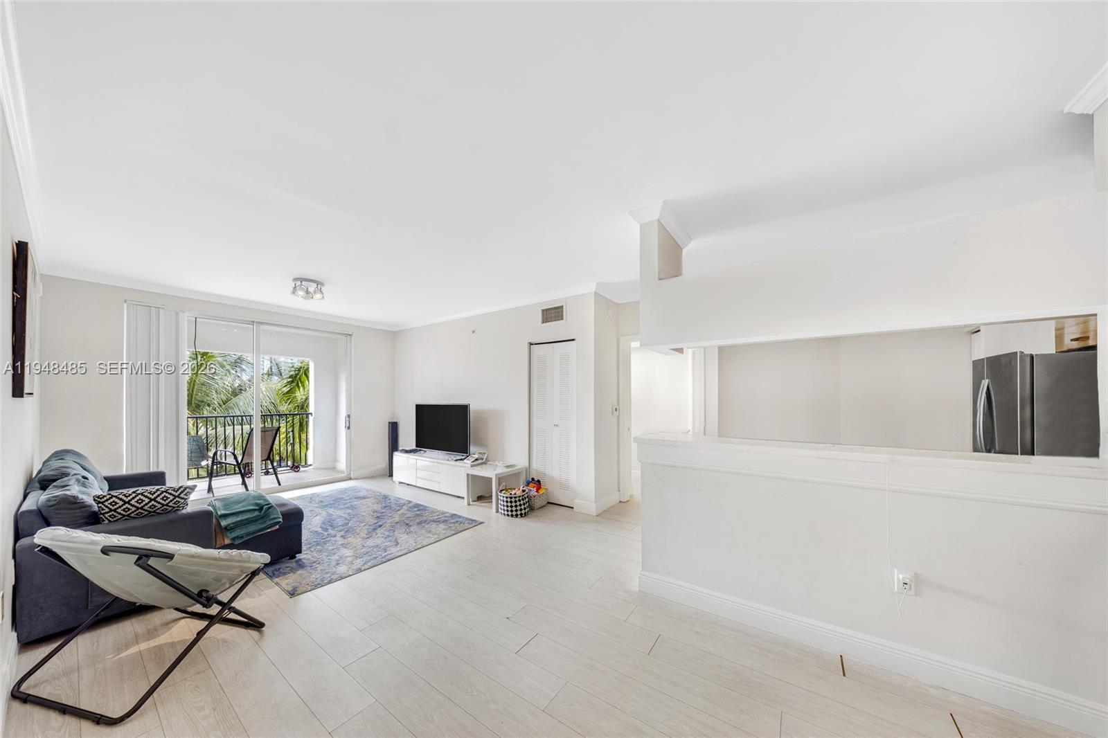 17145 North Bay Road, Unit 4506 Sunny Isles Beach, FL 33160 - Photo 3 of 10 a view of a livingroom with workspace and a window